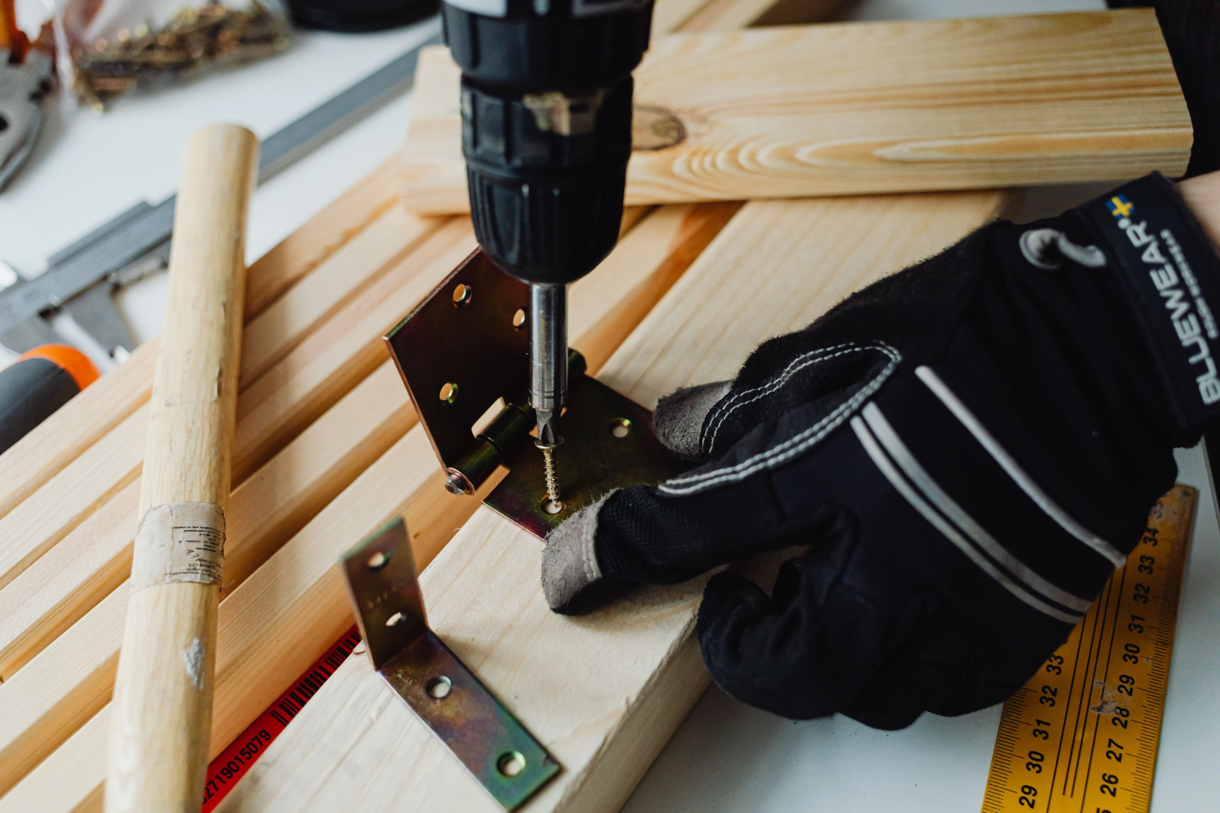 Handyman using a drill to assemble a wood project